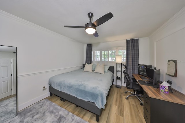 bedroom featuring light wood-style floors, baseboards, ornamental molding, and ceiling fan