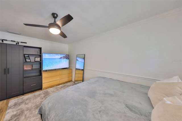 bedroom featuring crown molding and ceiling fan