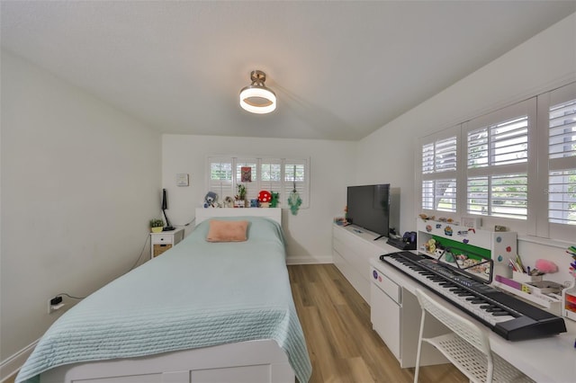 bedroom with light wood-style floors and baseboards