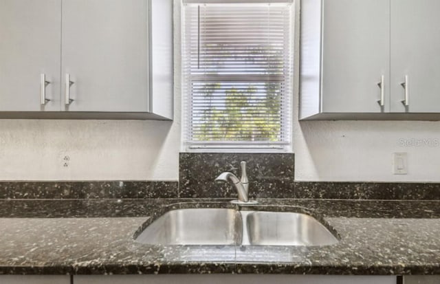 1247 21st St, Sarasota, FL 34234 - kitchen view of a sink and dark stone countertops