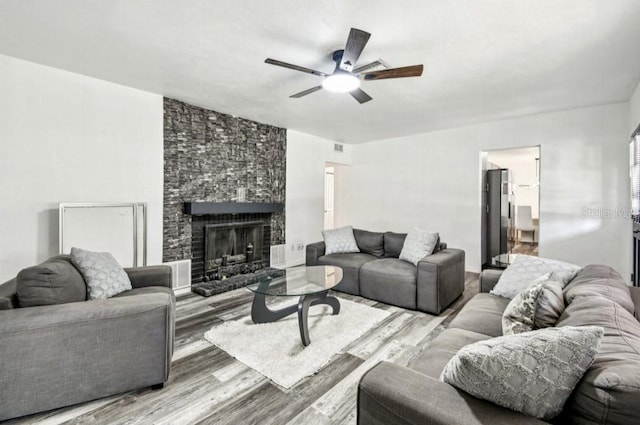 1247 21st St, Sarasota, FL 34234 - living area featuring wood finished floors, ceiling fan, and a fireplace