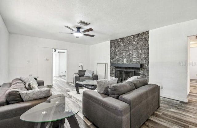 1247 21st St, Sarasota, FL 34234 - living area with wood finished floors, ceiling fan, and a fireplace