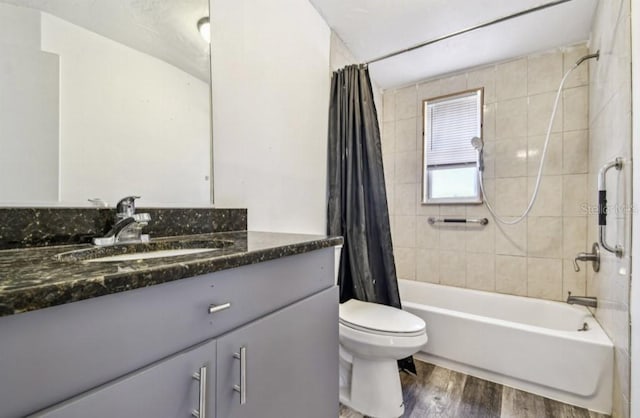 1247 21st St, Sarasota, FL 34234 - bathroom with wood finished floors, shower / bath combo with shower curtain, vanity, and toilet
