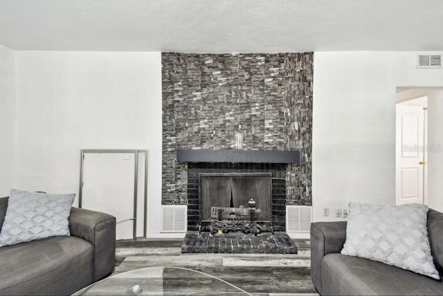 1247 21st St, Sarasota, FL 34234 - living room featuring wood finished floors and a fireplace