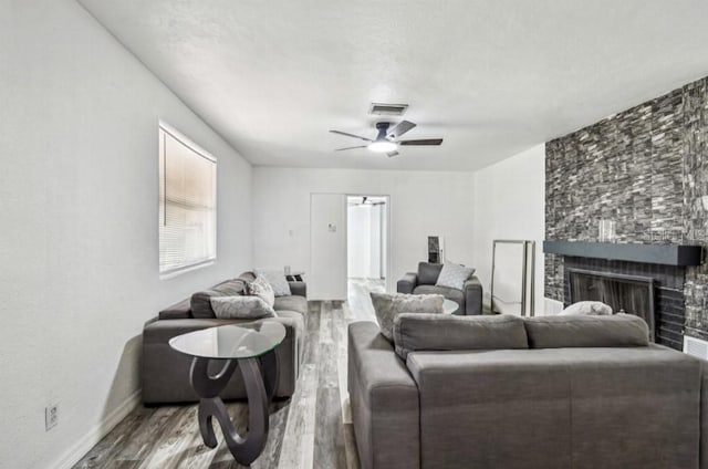 1247 21st St, Sarasota, FL 34234 - living area featuring wood finished floors, a fireplace, ceiling fan, and baseboards