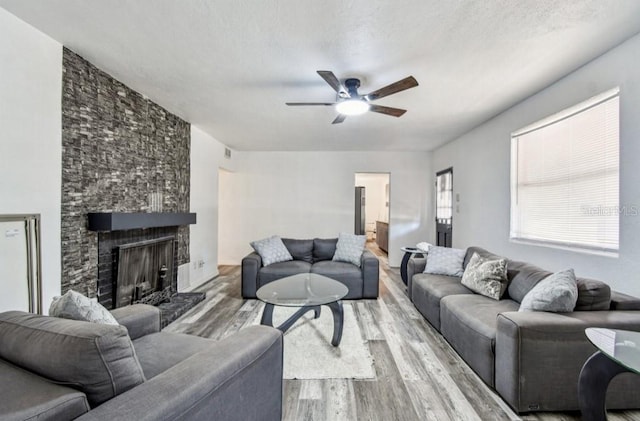1247 21st St, Sarasota, FL 34234 - living room with ceiling fan, wood finished floors, and a large fireplace