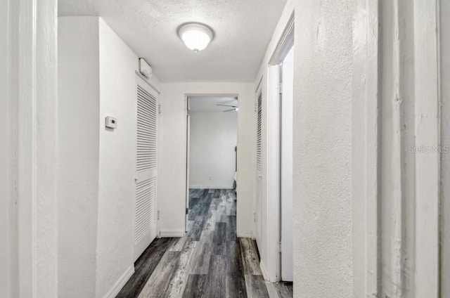 1247 21st St, Sarasota, FL 34234 - hall featuring wood finished floors, a textured wall, a textured ceiling, and baseboards
