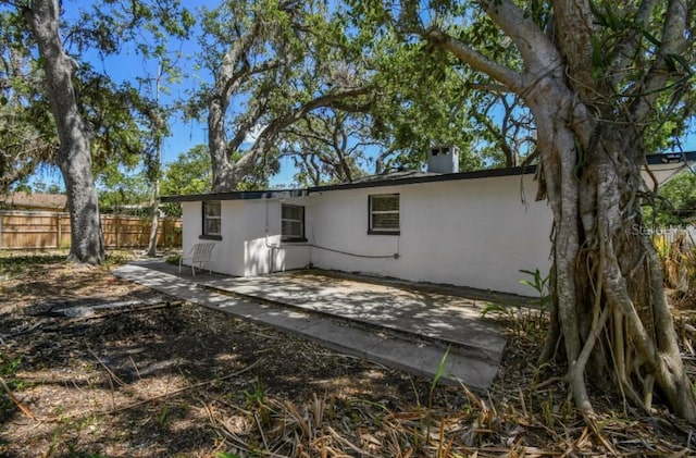 1247 21st St, Sarasota, FL 34234 - rear view of property with a patio area, a chimney, and stucco siding