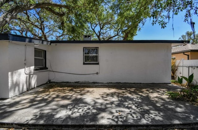 1247 21st St, Sarasota, FL 34234 - back of property featuring stucco siding and a patio