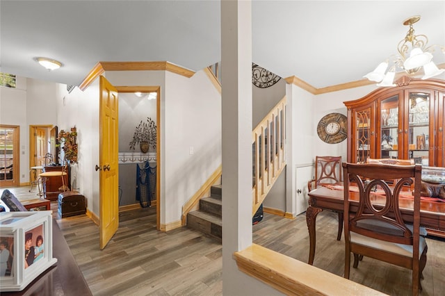 interior space featuring stairway, baseboards, wood finished floors, and a notable chandelier