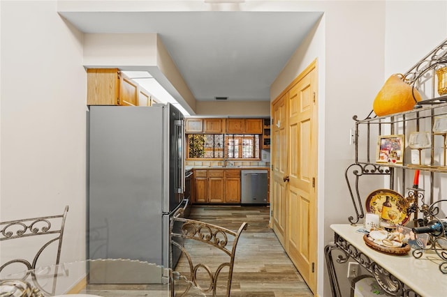 kitchen with visible vents, wood finished floors, light countertops, a sink, and stainless steel appliances