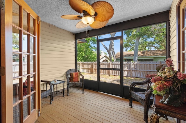 sunroom / solarium featuring ceiling fan