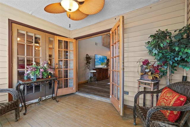 interior space with a ceiling fan, visible vents, and french doors