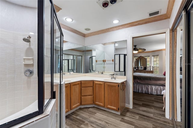 bathroom featuring visible vents, ornamental molding, tiled shower, and ensuite bath