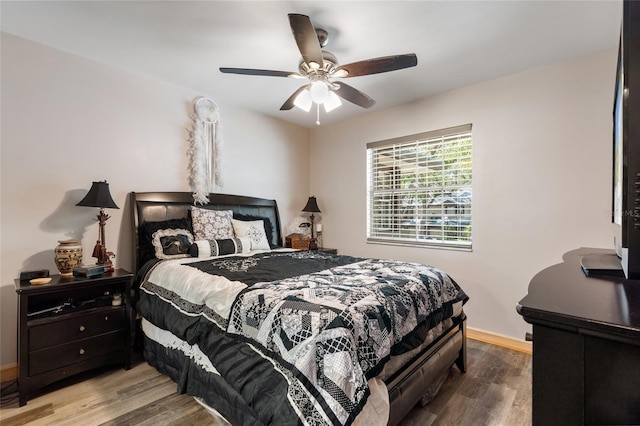 bedroom with baseboards, ceiling fan, and wood finished floors