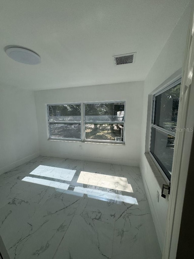 547 16th Ave S, Saint Petersburg, FL 33701 - empty room with marble look tile flooring and baseboards