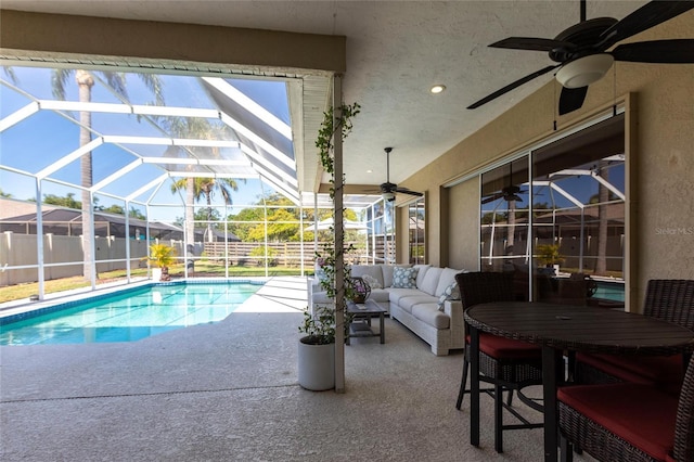view of swimming pool with an outdoor living space, a ceiling fan, a patio area, fence, and a fenced in pool