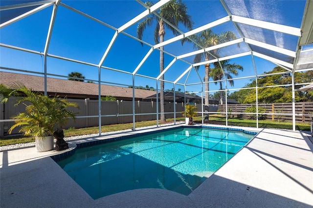 view of pool with a fenced in pool, a fenced backyard, glass enclosure, and a patio area