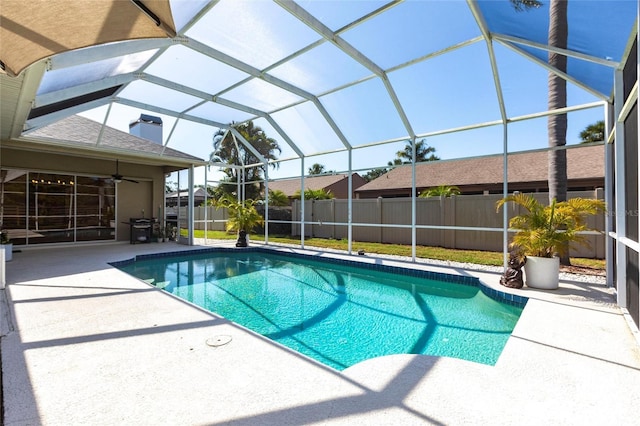 view of pool featuring fence, a fenced in pool, a lanai, a ceiling fan, and a patio