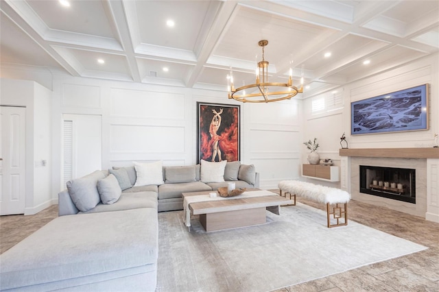 living area featuring coffered ceiling, a decorative wall, beam ceiling, and a chandelier