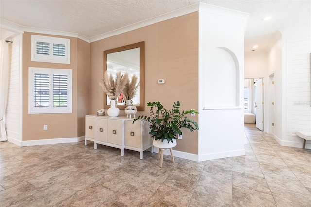 corridor with baseboards and ornamental molding