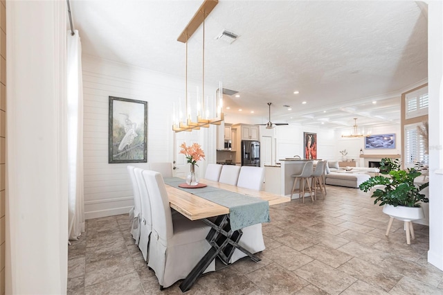 dining room with visible vents, recessed lighting, stone finish flooring, and ceiling fan with notable chandelier