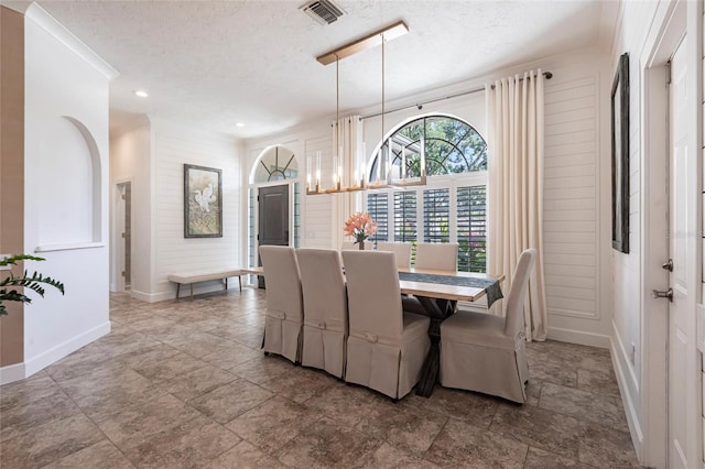 dining space with a textured ceiling, baseboards, visible vents, and recessed lighting