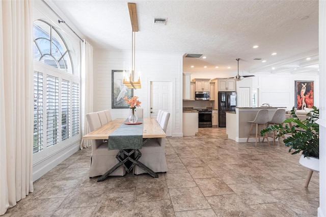 dining space featuring a healthy amount of sunlight, recessed lighting, a textured ceiling, and visible vents