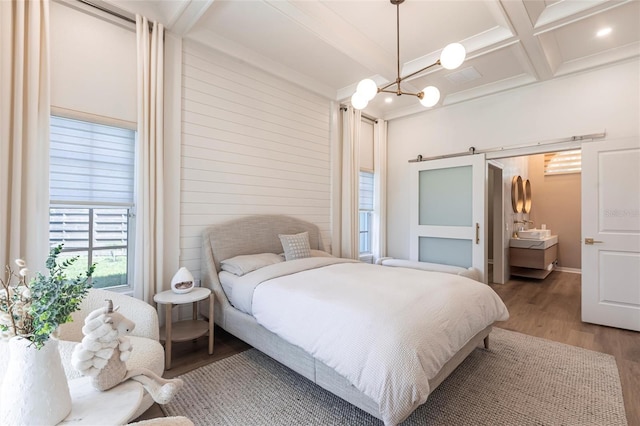 bedroom with an inviting chandelier, coffered ceiling, wood finished floors, and beam ceiling