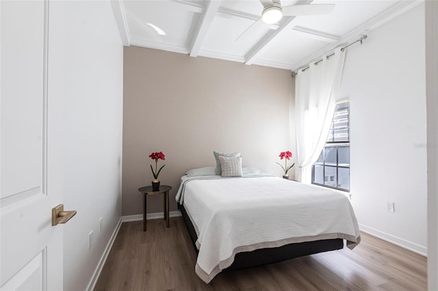 bedroom featuring baseboards, ceiling fan, beamed ceiling, and wood finished floors