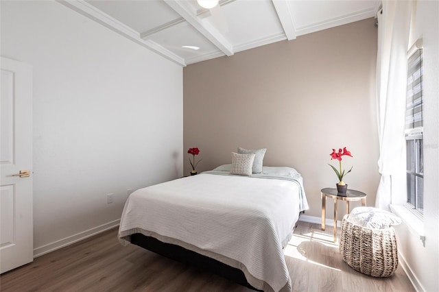 bedroom featuring baseboards, coffered ceiling, wood finished floors, and beamed ceiling