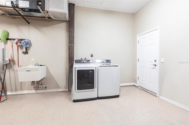 laundry room featuring a sink, separate washer and dryer, baseboards, and laundry area