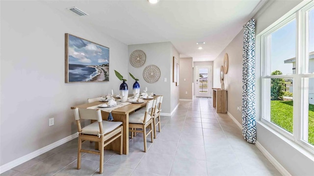 dining room featuring visible vents, baseboards, plenty of natural light, and light tile patterned floors
