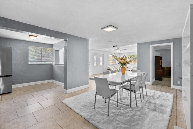 2026 Cocoanut Ave, Sarasota, FL 34234 - dining space featuring a textured wall, a ceiling fan, a healthy amount of sunlight, and tile patterned floors