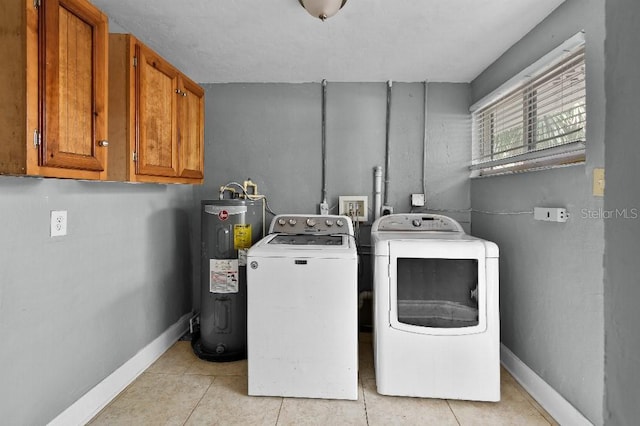 2026 Cocoanut Ave, Sarasota, FL 34234 - laundry area featuring light tile patterned floors, cabinet space, baseboards, electric water heater, and independent washer and dryer