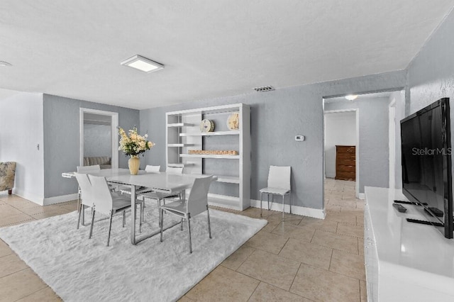 2026 Cocoanut Ave, Sarasota, FL 34234 - dining space with baseboards, light tile patterned flooring, and built in features
