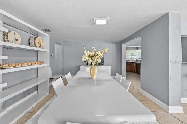 2026 Cocoanut Ave, Sarasota, FL 34234 - dining area with a textured ceiling, light tile patterned flooring, baseboards, and visible vents