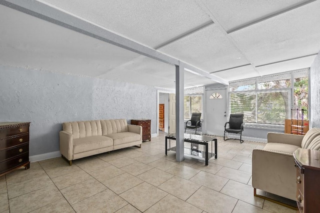 2026 Cocoanut Ave, Sarasota, FL 34234 - living room featuring light tile patterned floors and a textured wall