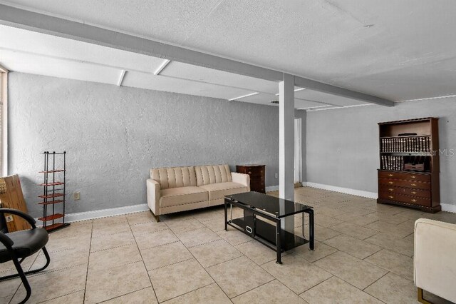 2026 Cocoanut Ave, Sarasota, FL 34234 - tiled living area with a textured ceiling, baseboards, and a textured wall