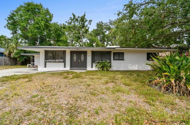 2026 Cocoanut Ave, Sarasota, FL 34234 - ranch-style house with concrete driveway, stucco siding, fence, and a front yard