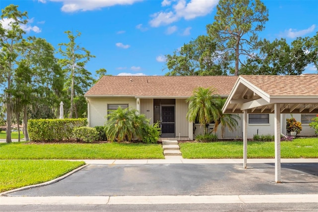 15 Tads Trl, Oldsmar, FL 34677 - view of front of home featuring uncovered parking, a front lawn, and a shingled roof