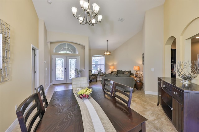 dining room with french doors, visible vents, arched walkways, high vaulted ceiling, and a notable chandelier