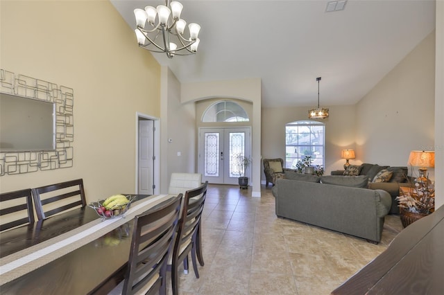 living room featuring a notable chandelier, high vaulted ceiling, french doors, light tile patterned floors, and visible vents