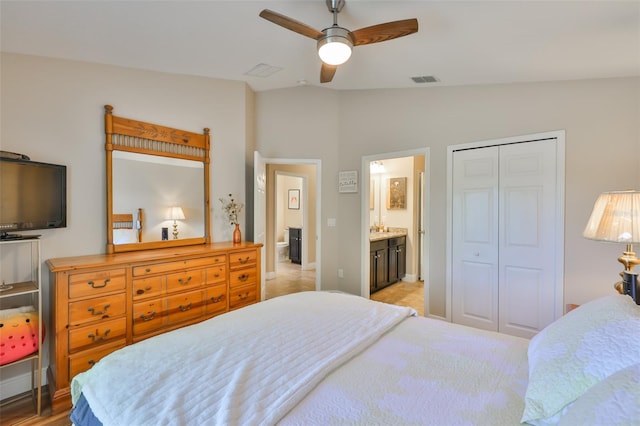 bedroom with connected bathroom, a ceiling fan, lofted ceiling, visible vents, and a closet