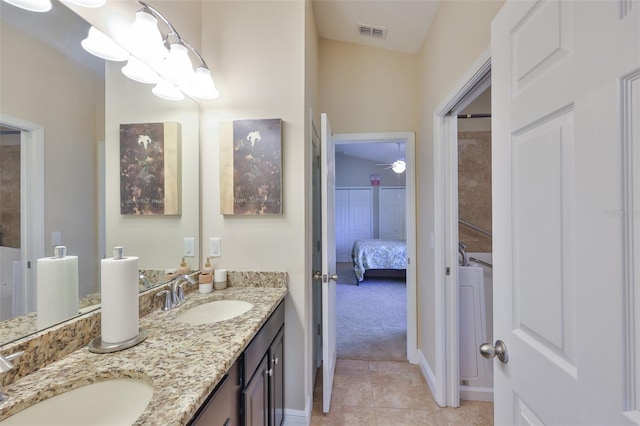 bathroom with double vanity, visible vents, a sink, and tile patterned flooring