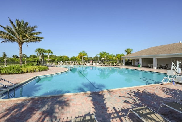 pool with fence and a patio area