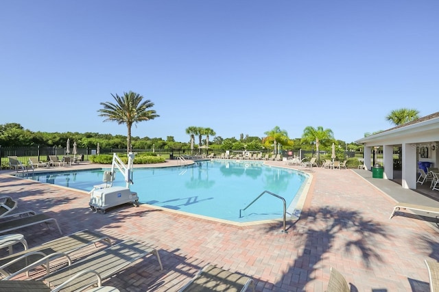 pool featuring fence and a patio