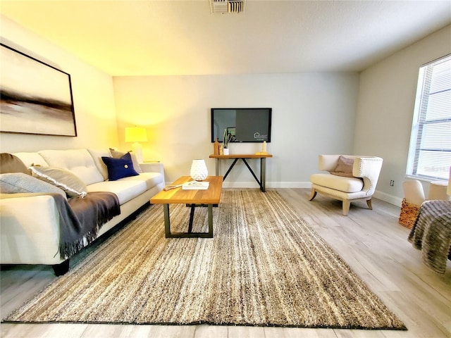 3529 Tanglewood Trl, Palm Harbor, FL 34685 - living area with visible vents, baseboards, and wood finished floors