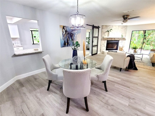3529 Tanglewood Trl, Palm Harbor, FL 34685 - dining area featuring baseboards, ceiling fan with notable chandelier, and light wood-type flooring
