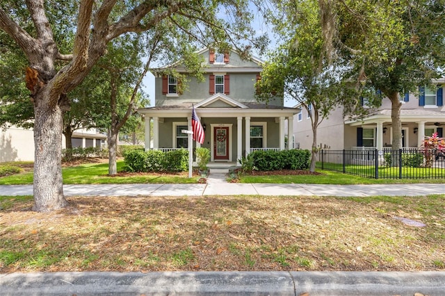 traditional style home featuring a porch, fence, a front lawn, and stucco siding